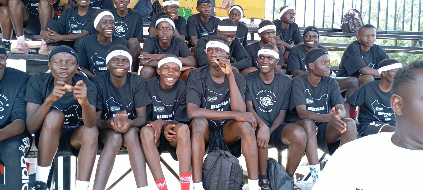 Young basketball players seated together on the bleachers
